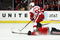 CHICAGO - MAY 24:  Johan Franzen #93 of the Detroit Red Wings skates with the puck as Brent Seabrook #7 the Chicago Blackhawks slides head first down the ice behind him during Game Four of the Western Conference Championship Round of the 2009 Stanley Cup Playoffs on May 24, 2009 at the United Center in Chicago, Illinois.  (Photo by Jonathan Daniel/Getty Images)