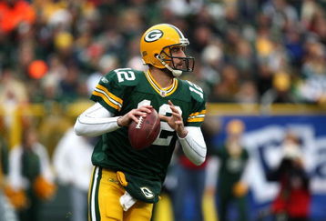 GREEN BAY, WI - NOVEMBER 30:  Aaron Rodgers #12 of the Green Bay Packers rolls out to pass against the Carolina Panthers at Lambeau Field on November 30, 2008 in Green Bay, Wisconsin. The Panthers won 35-31. (Photo by Jonathan Daniel/Getty Images)
