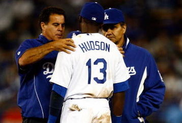 LOS ANGELES, CA - MAY 19:  Orlando Hudson #13 of the Los Angeles Dodgers is attended to by a trainer (L) after suffering an injury as Manager Joe Torre looks on against the New York Mets in the seventh inning at Dodger Stadium on May 19, 2009 in Los Angeles, California.  (Photo by Jeff Gross/Getty Images)