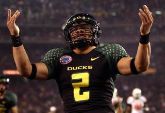 SAN DIEGO, CA - DECEMBER 30:   Quarterback Jeremiah Masoli #2 of the University of Oregon Ducks runs into the endzone for a touchdown against the Oklahoma State University Cowboys during the Pacific Life Holiday Bowl at Qualcomm Stadium on December 30, 2008 in San Diego, California. The Ducks won 42-31. (Photo by Donald Miralle/Getty Images)