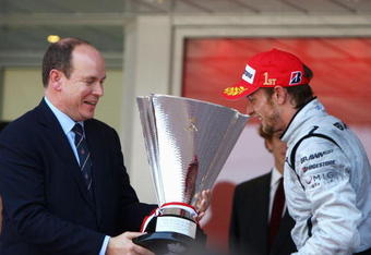 MONTE CARLO, MONACO - MAY 24:  Jenson Button of Great Britain and Brawn GP is presented with the winners trophy by Prince Albert II of Monaco after his victory in the Monaco Formula One Grand Prix at the Monte Carlo Circuit on May 24, 2009 in Monte Carlo, Monaco.  (Photo by Paul Gilham/Getty Images)
