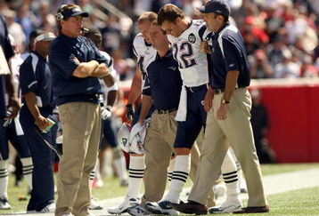 FOXBORO, MA - SEPTEMBER 7:  Quarterback Tom Brady #12 of the New England Patriots walks off the field with the aid of the Patriots staff after being injured on a play during their NFL game against the Kansas City Chiefs on September 7, 2008 at Gillette Stadium in Foxboro, Massachusetts. The Patriots defeated the Chiefs 17-10. (Photo by Elsa Garrison/Getty Images)