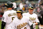 OAKLAND, CA - MAY 23:  Jack Cust #32 of the Oakland Athletics is congratulated by Matt Holliday after Cust hit a two-run home run that scored Kurt Suzuki #8 in the first inning of their game against the Arizona Diamondbacks at the Oakland Coliseum on May 23, 2009 in Oakland, California.  (Photo by Ezra Shaw/Getty Images)