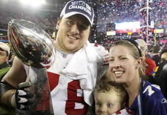 GLENDALE, AZ - FEBRUARY 03:  (L-R) Chris Snee #76 of the New York Giants wife Kate and son Dylan celebrate after the Giants defeated the New England Patriots 17-14 during Super Bowl XLII on February 3, 2008 at the University of Phoenix Stadium in Glendale, Arizona.  Katie Snee is the daughter of New York Giants coach Tom Coughlin. (Photo by Andy Lyons/Getty Images)