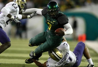 EUGENE, OR - AUGUST 30:  Quarterback Chris Harper #3 of the Oregon Ducks is tackled by Mesphin Forrester #23 and Trenton Tuiasosopo #57 of the Washington Huskies at Autzen Stadium on August 30, 2008 in Eugene, Oregon.  (Photo by Jonathan Ferrey/Getty Images)