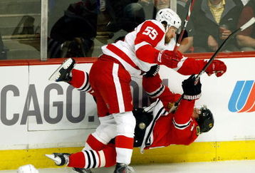 CHICAGO - MAY 22:  Martin Havlat #24 of the Chicago Blackhawks checked hard to the ice by Niklas Kronwall #55 of the Detroit Red Wings during the first period of Game Three of the Western Conference Championship Round of the 2009 Stanley Cup Playoffs on May 22, 2009 at the United Center in Chicago, Illinois.  (Photo by Jim Prisching/Getty Images)