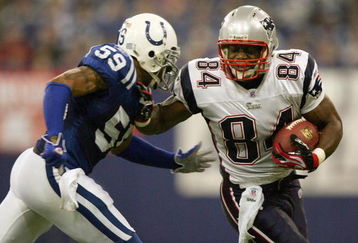INDIANAPOLIS - JANUARY 21:  Benjamin Watson #84 of the New England Patriots tries to get past Cato June #59 of the Indianapolis Colts during the AFC Championship Game on January 21, 2007 at the RCA Dome in Indianapolis, Indiana.  (Photo by Jed Jacobsohn/Getty Images)