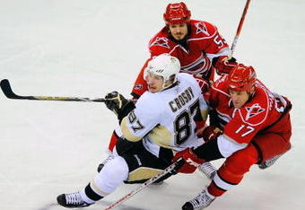 RALEIGH, NC - MAY 26:  Sidney Crosby #87 of the Pittsburgh Penguins battles for the puck against Chad LaRose #59 and Rod Brind'Amour #17 of the Carolina Hurricanes during Game Four of the Eastern Conference Championship Round of the 2009 Stanley Cup Playoffs at RBC Center May 26, 2009 in Raleigh, North Carolina.  (Photo by Grant Halverson/Getty Images)