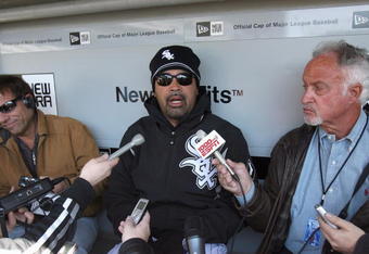 CHICAGO - APRIL 7:  Manager Ozzie Guillen #13 of the Chicago White Sox talks with the press in the dugout before the Opening Day game against the Kansas City Royals on April 7, 2009 at U.S. Cellular Field in Chicago, Illinois. (Photo by Jonathan Daniel/Getty Images) 