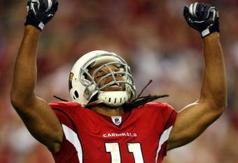 GLENDALE, AZ - JANUARY 18:  Wide receiver Larry Fitzgerald #11 of the Arizona Cardinals reacts after teammate Tim Hightower #34 scored a touchdown in the fourth quarter against the Philadelphia Eagles during the NFC championship game on January 18, 2009 at University of Phoenix Stadium in Glendale, Arizona.  (Photo by Jamie Squire/Getty Images)