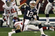 GLENDALE, AZ - FEBRUARY 03:  Quarterback Tom Brady #12 of the New England Patriots celebrates a second quarter touchdown against the New York Giants during Super Bowl XLII on February 3, 2008 at the University of Phoenix Stadium in Glendale, Arizona.  (Photo by Win McNamee/Getty Images)