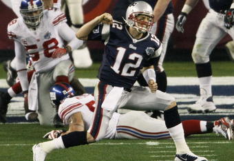 GLENDALE, AZ - FEBRUARY 03:  Quarterback Tom Brady #12 of the New England Patriots celebrates a second quarter touchdown against the New York Giants during Super Bowl XLII on February 3, 2008 at the University of Phoenix Stadium in Glendale, Arizona.  (Photo by Win McNamee/Getty Images)