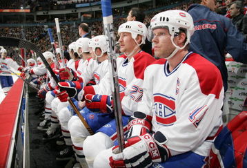 VANCOUVER - JANUARY 21:  Saku Koivu #11 and Alex Kovalev #27 of the Montreal Canadiens look on from the bench during the NHL game against the Vancouver Canucks on January 21, 2006 at General Motors Place in Vancouver, Canada. The Canucks defeated the Canadiens 6-2.  (Photo by Jeff Vinnick/Getty Images)