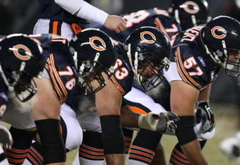 CHICAGO - DECEMBER 22: Members of the Chicago Bear offensive line including Olin Kreutz #57, Roberto Garza #63 and John Tait #76 line-up in front of the Green Bay Packer defense on December 22, 2008 at Soldier Field in Chicago, Illinois. The Bears defeated the Packers 20-17 in overtime. (Photo by Jonathan Daniel/Getty Images)