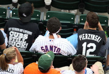 CHICAGO - JUNE 27:  A fan of the Chicago Cubs sits between two fans of the Chicago White Sox at U.S. Cellular Field on June 27, 2008 in Chicago, Illinois.  (Photo by Jonathan Daniel/Getty Images)