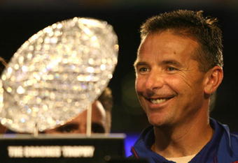 MIAMI - JANUARY 08:  Urban Meyer of the Florida Gators smiles as he is presented with the National Championship trophy after their 24-14 win against the Oklahoma Sooners during the FedEx BCS National Championship game at Dolphin Stadium on January 8, 2009 in Miami, Florida.  (Photo by Marc Serota/Getty Images)