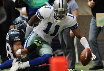 IRVING, TX - NOVEMBER 27:  Wide receiver Roy Williams #11 of the Dallas Cowboys is tackled by Julian Peterson #98 of the Seattle Seahawks at Texas Stadium on November 27, 2008 in Irving, Texas.  (Photo by Ronald Martinez/Getty Images)