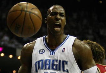 ORLANDO, FL - MAY 24:  Dwight Howard #12 of the Orlando Magic reacts after a dunk against the Cleveland Cavaliers in Game Three of the Eastern Conference Finals during the 2009 NBA Playoffs at the the Amway Arena on May 24, 2009 in Orlando, Florida. NOTE TO USER: User expressly acknowledges and agrees that, by downloading and or using this photograph, User is consenting to the terms and conditions of the Getty Images License Agreement.  (Photo by Elsa/Getty Images)