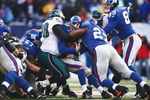 EAST RUTHERFORD, NJ -  JANUARY 11:  Eli Manning #10 of the New York Giants is tackled by Mike Patterson #98 of the Philadelphia Eagles during the NFC Divisional Playoff Game on January 11, 2009 at Giants Stadium in East Rutherford, New Jersey.  The Eagles defeated the Giants 23 -11. (Photo by Chris McGrath/Getty Images)