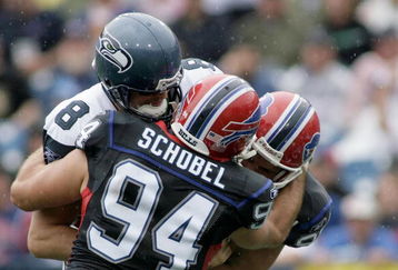 BUFFALO, NY - SEPTEMBER 07:  Aaron Schobel #94 and Chris Kelsay #90 of the Buffalo Bills tackle Matt Hasselbeck #8 of the Seattle Seahawks at Ralph Wilson Stadium on September 7, 2008 in Orchard Park, New York.  (Photo by Rick Stewart/Getty Images)