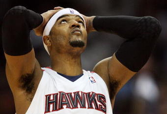 ATLANTA - MAY 03:  Josh Smith #5 of the Atlanta Hawks takes a moment and looks up with less than a minute to play against the Miami Heat during Game Seven of the Eastern Conference Quarterfinals at Philips Arena on May 3, 2009 in Atlanta, Georgia. The Hawks defeated the Heat 91-78. NOTE TO USER: User expressly acknowledges and agrees that, by downloading and/or using this Photograph, user is consenting to the terms and conditions of the Getty Images License Agreement.  (Photo by Doug Benc/Getty Images)