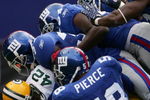 EAST RUTHERFORD, NJ - SEPTEMBER 16:  DeShawn Wynn #42 of the Green Bay Packers is tackled by five New York Giants defenders at Giants Stadium September 16, 2007 in East Rutherford, New Jersey.  (Photo by Chris McGrath/Getty Images)
