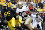 ANN ARBOR, MI - SEPTEMBER 15:  Golden Tate #23 of the Notre Dame Fighting Irish tries to turn the corner in front of Brandon Graham #55 of Michigan Wolverines at Michigan Stadium September 15, 2007 in Ann Arbor, Michigan. Michigan won the game 38-0.  (Photo by Gregory Shamus/Getty Images)