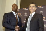 LIBERTYVILLE, IL - JANUARY 15:  Chicago Bears General Manager Jerry Angelo (R) congratulates former defensive coordinator for the St. Louis Rams, Lovie Smith (L), on his four year contract as head coach of the Chicago Bears at a media conference on January 15, 2004 in Libertyville, Illinois.  (Photo by Aynsley Floyd/Getty Images)