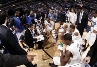 MEMPHIS, TN - MARCH 14:  Head coach John Calipari of the Memphis Tigers meets with his team at a time out during the Championship of the Conference USA Basketball Tournament at FedExForum on March 14, 2009 in Memphis, Tennessee. (Photo by Joe Murphy/Getty Images)