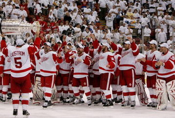 PITTSBURGH - JUNE 04: Nicklas Lidstrom #5 of the Detroit Red Wings hands off to Dallas Drake #5 as they celebrate with the Stanley Cup after defeating the Pittsburgh Penguins in game six of the 2008 NHL Stanley Cup Finals at Mellon Arena on June 4, 2008 in Pittsburgh. Pennsylvania. The Red Wings defeated the Penguins 3-2 to win the Stanley Cup Finals 4 games to 2. (Photo by Bruce Bennett/Getty Images)