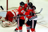 CHICAGO - MAY 24:  Patrick Kane #88 and Jonathan Toews #19 of the Chicago Blackhawks celebrate after Toews scored a goal in the second period against goalie Chris Osgood #30 of the Detroit Red Wings during Game Four of the Western Conference Championship Round of the 2009 Stanley Cup Playoffs on May 24, 2009 at the United Center in Chicago, Illinois.  (Photo by Jim Prisching/Getty Images)
