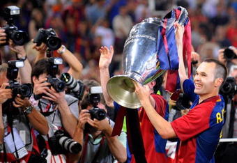 ROME, ITALY - MAY 27:  Andres Iniesta of Barcelona celebrates with the trophy after the UEFA Champions League Final match between Barcelona and Manchester United at the Stadio Olimpico on May 27, 2009 in Rome, Italy.  (Photo by Claudio Villa/Getty Images)