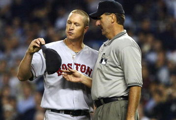 BRONX, NY - OCTOBER 8:  Home plate umpire Tim McClelland inspects Boston Red Sox pitcher Mike Timlin's hat after being instructed to do so by manger Joe Torre of the New York Yankees during game 1 of the American League Championship Series on October 8, 2003 at Yankee Stadium in the Bronx, New York.  (Photo by Doug Pensinger/Getty Images)