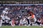 DENVER - NOVEMBER 23:  Wide receiver Brandon Marshall #15 of the Denver Broncos leaves the line of scrimmage against cornerback Nnamdi Asomgha #21 of the Oakland Raiders during week 12 NFL action at Invesco Field at Mile High on November 23, 2008 in Denver, Colorado. The Raiders defeated the Broncos 31-10.  (Photo by Doug Pensinger/Getty Images)