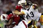 TAMPA, FL - FEBRUARY 01:  Troy Polamalu #43 of the Pittsburgh Steelers attempts to tackle Tim Hightower #34 of the Arizona Cardinals during the first quarter of Super Bowl XLIII on February 1, 2009 at Raymond James Stadium in Tampa, Florida.  (Photo by Streeter Lecka/Getty Images)