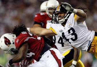 TAMPA, FL - FEBRUARY 01:  Troy Polamalu #43 of the Pittsburgh Steelers attempts to tackle Tim Hightower #34 of the Arizona Cardinals during the first quarter of Super Bowl XLIII on February 1, 2009 at Raymond James Stadium in Tampa, Florida.  (Photo by Streeter Lecka/Getty Images)