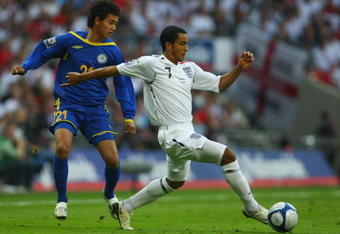 LONDON - OCTOBER 11:  Theo Walcott of England evades Zhambyi Kukeyev of Kazakhstan during the 2010 World Cup qualifying match between England and Kazakhstan at Wembley Stadium on October 11, 2008 in London, England.  (Photo by Clive Rose/Getty Images)