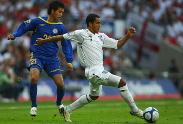 LONDON - OCTOBER 11:  Theo Walcott of England evades Zhambyi Kukeyev of Kazakhstan during the 2010 World Cup qualifying match between England and Kazakhstan at Wembley Stadium on October 11, 2008 in London, England.  (Photo by Clive Rose/Getty Images)