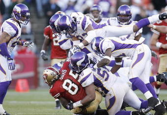 SAN FRANCISCO - DECEMBER 9:  Tight end Vernon Davis #85 of the San Francisco 49ers is swarmed by the Minnesota Vikings defenders during a game on December 9, 2007 at Monster Park in San Francisco, California. (Photo by Greg Trott/Getty Images)