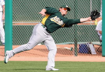 MESA, AZ - MARCH 03:  Jack Cust #32 of the Oakland Athletics makes a lundging catch during the spring training against the Chicago Cubs game at HoHoKam Park on March 3, 2009 in Mesa, Arizona. The Cubs defeated the A's 6-4.  (Photo by Christian Petersen/Getty Images)