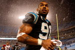 CHARLOTTE, NC - JANUARY 10:  Julius Peppers #89 of the Carolina Panthers walks off the field in the rain after being defeated by the Arizona Cardinals 33-13 in the NFC Divisional Playoff Game on January 10, 2009 at Bank of America Stadium in Charlotte, North Carolina.  (Photo by Streeter Lecka/Getty Images)
