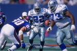 4 Oct 1997:  Emmitt Smith #22 of the Dallas Cowboys runs with the ball  as teammate Larry Allen #73 sets up to block Corey Widmer #90 of the New York Giants during a game at the Meadowlands in East Rutherford, New Jersey. The Giants defeated the Cowboys 2