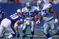 4 Oct 1997:  Emmitt Smith #22 of the Dallas Cowboys runs with the ball  as teammate Larry Allen #73 sets up to block Corey Widmer #90 of the New York Giants during a game at the Meadowlands in East Rutherford, New Jersey. The Giants defeated the Cowboys 2