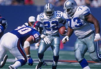 4 Oct 1997:  Emmitt Smith #22 of the Dallas Cowboys runs with the ball  as teammate Larry Allen #73 sets up to block Corey Widmer #90 of the New York Giants during a game at the Meadowlands in East Rutherford, New Jersey. The Giants defeated the Cowboys 2