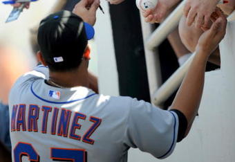 FORT LAUDERDALE, FL - FEBRUARY 25: Fernando Martinez #67 of the New York Mets signs autographs before a game against the Baltimore Orioles during spring training at Fort Lauderdale Stadium on February 25, 2009 in Fort Lauderdale, Florida. (Photo by Rob Tringali/Getty Images)
