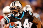 CHARLOTTE, NC - JANUARY 10:  Running back DeAngelo Williams #34 of the Carolina Panthers runs the ball against the Arizona Cardinals during the first quarter of the NFC Divisional Playoff Game on January 10, 2009 at Bank of America Stadium in Charlotte, North Carolina.  (Photo by Streeter Lecka/Getty Images)