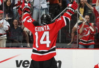 NEWARK, NJ - APRIL 28: Brian Gionta #14 of the New Jersey Devils celebrates a goal by Brian Rolston #12 (not shown) against the Carolina Hurricanes during Game Seven of the Eastern Conference Semifinal Round of the 2009 Stanley Cup Playoffs at the Prudential Center on April 28, 2009 in Newark, New Jersey. The Hurricanes defetaed the Devils 4-3.  (Photo by Bruce Bennett/Getty Images)