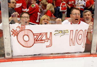 DETROIT - MAY 27:  Fans of the Detroit Red Wings hold up a sign which reads '#30 Ozzy says NO!' in support of goalie Chris Osgood #30 of the Red Wings after the WIngs won 2-1 in overtime against the Chicago Blackhawks during Game Five of the Western Conference Championship Round of the 2009 Stanley Cup Playoffs on May 27, 2009 at Joe Louis Arena in Detroit, Michigan.  (Photo by Gregory Shamus/Getty Images)