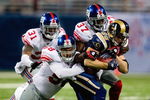ST. LOUIS, MO - SEPTEMBER 14: Dane Looker #89 of the St. Louis Rams is tackled by Antonio Pierce #58, James Butler #37 and Aaron Boss #31 all of the New York Giants at the Edward Jones Dome on September 14, 2008 in St. Louis, Missouri. The Giants beat the Rams 41-13. (Photo by Dilip Vishwanat/Getty Images)