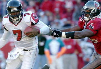 Atlanta Falcons quarterback Michael Vick scrambles from the Tampa Bay Buccaneers  pass rush December 20, 2003 at Raymond James Stadium, Tampa, Florida.  The Falcons defeated the Bucs 30 - 28.  (Photo by Al Messerschmidt/Getty Images)